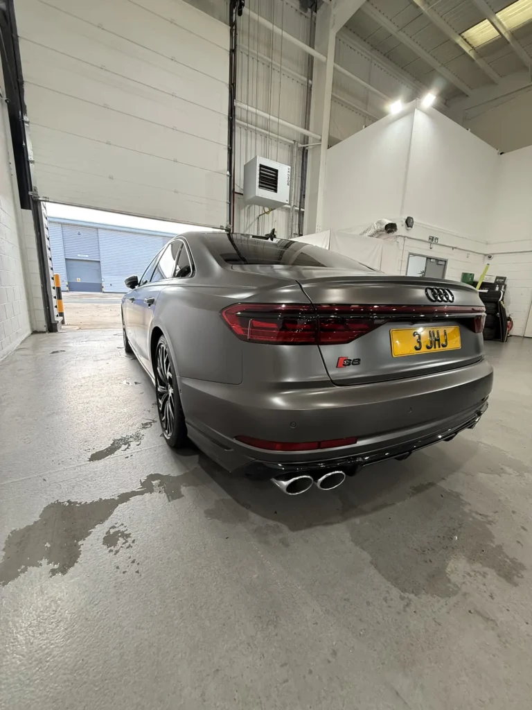 Grey Audi S8 viewed from the rear inside the detailing workshop